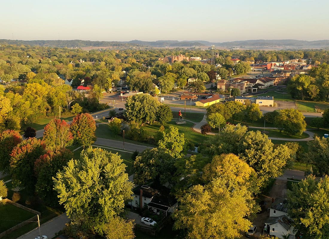 Britt, IA - Aerial View of a Small Town of Britt Iowa Surrounded by Green Trees on a Sunny Day
